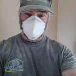 Dusty worker in construction attire.