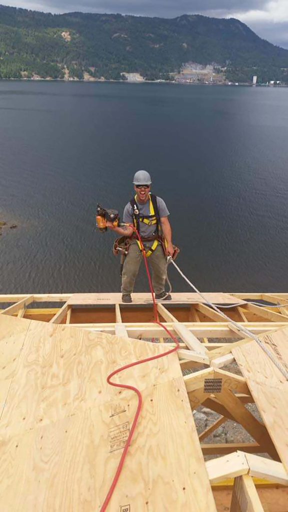 Construction worker on wooden platform.